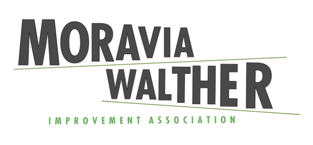 Moravia-Walther Improvement Association logo. The words "Moravia-Walther" are in large black text at and angle to mimic a road sign, below in smaller green capital letters are the words "Improvement Association"